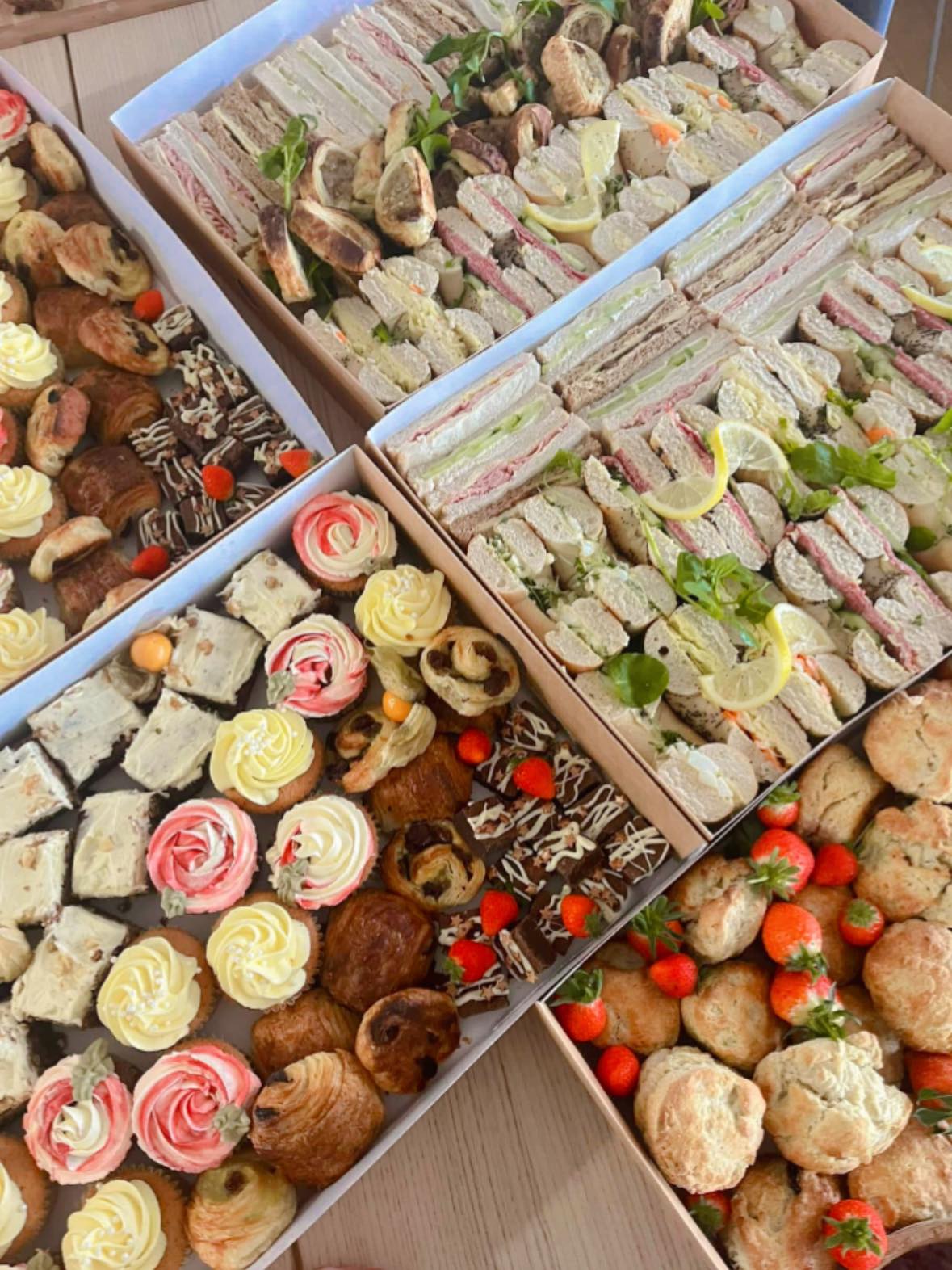 Corporate catering boxes with sandwiches, cupcakes and scones