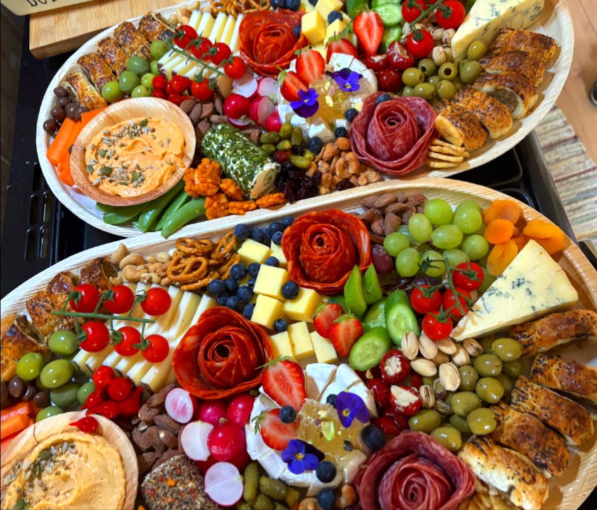 Sophisticated tiered grazing table with cured meats, cheeses and honeycomb