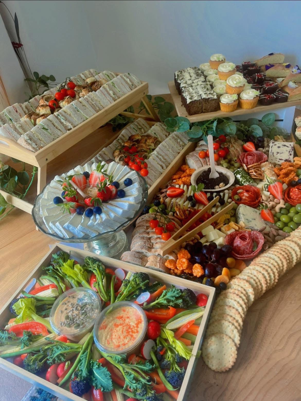 Elegant tiered platter with prosciutto and seasonal fruits