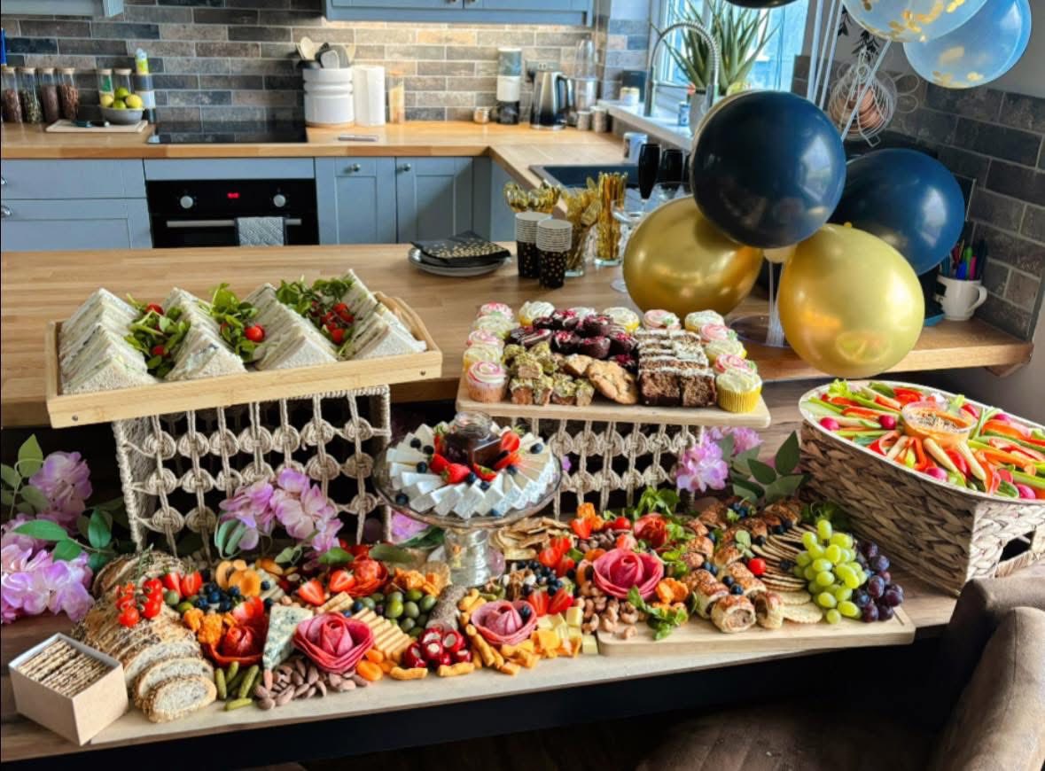 Lavish grazing table with extensive meats, cheeses and edible flowers