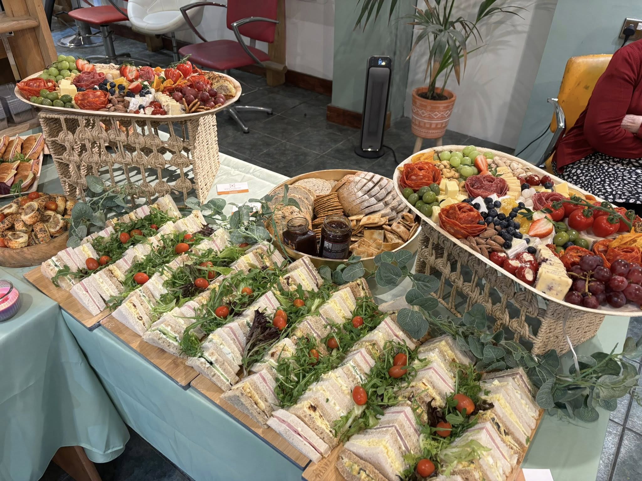 Corporate event catering spread with sandwiches, fruit and platters